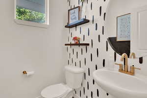 Half bathroom with a sink and toilet