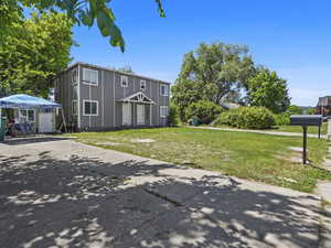 Back of house featuring a lawn