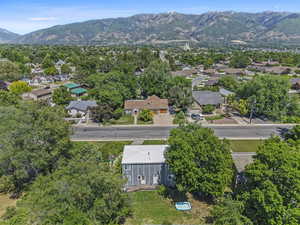 Aerial view of residential area featuring mountains and a tree filled landscape