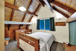 Bedroom with wood ceiling and carpet