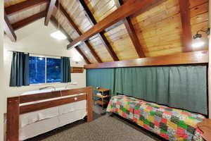 Bedroom featuring carpet floors and wooden ceiling
