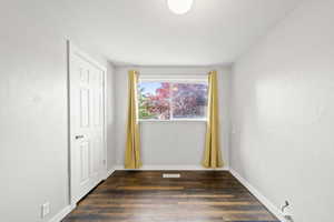 Empty room with dark wood finished floors