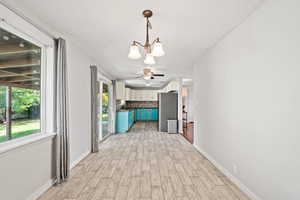 Interior space featuring a chandelier and wood tiled floors