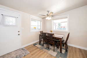 Dining area featuring light wood-type flooring and a ceiling fan