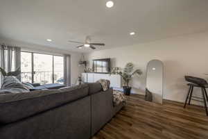 Living area with recessed lighting, dark wood-type flooring, and a ceiling fan
