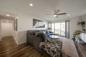 Living room featuring dark wood-style flooring, recessed lighting, and ceiling fan