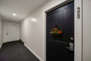 Doorway to property featuring a baseboard heating unit