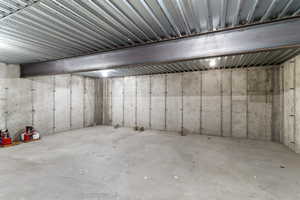 View of unfinished below grade area below garage, great for food storage and seasonal items