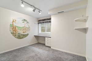 office with built in desk and carpet floors