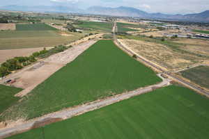 Aerial view of property's location featuring a mountainous background and rural landscape