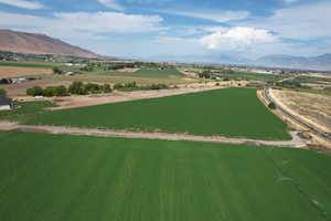 Overview of rural landscape featuring a mountainous background and farmland