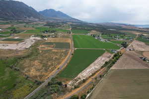 Aerial view of property and surrounding area featuring farmland and rural landscape