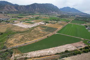 View of property location featuring rural landscape, a mountain backdrop, and farmland