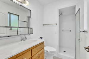 Full bath featuring vanity and a shower stall