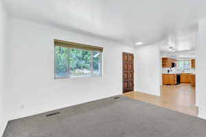 Empty room featuring light carpet and light wood finished floors