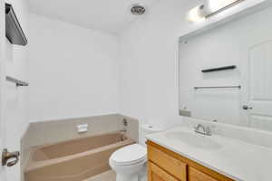 Full bath featuring vanity and a garden tub