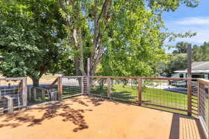 Wooden deck with a yard and a patio