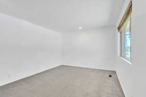 Spare room featuring carpet flooring and recessed lighting