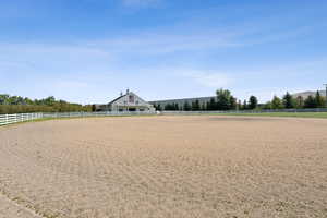 View of home's community with an enclosed horse arena and a view of rural / pastoral area
