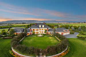 Aerial view of property and surrounding area featuring a mountainous background