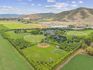 Aerial view of sparsely populated area featuring a mountain backdrop and farmland