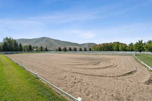 View of community featuring an enclosed horse arena, a rural view, and a mountain view