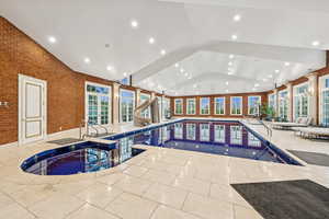 Indoor pool with a jacuzzi and a water slide