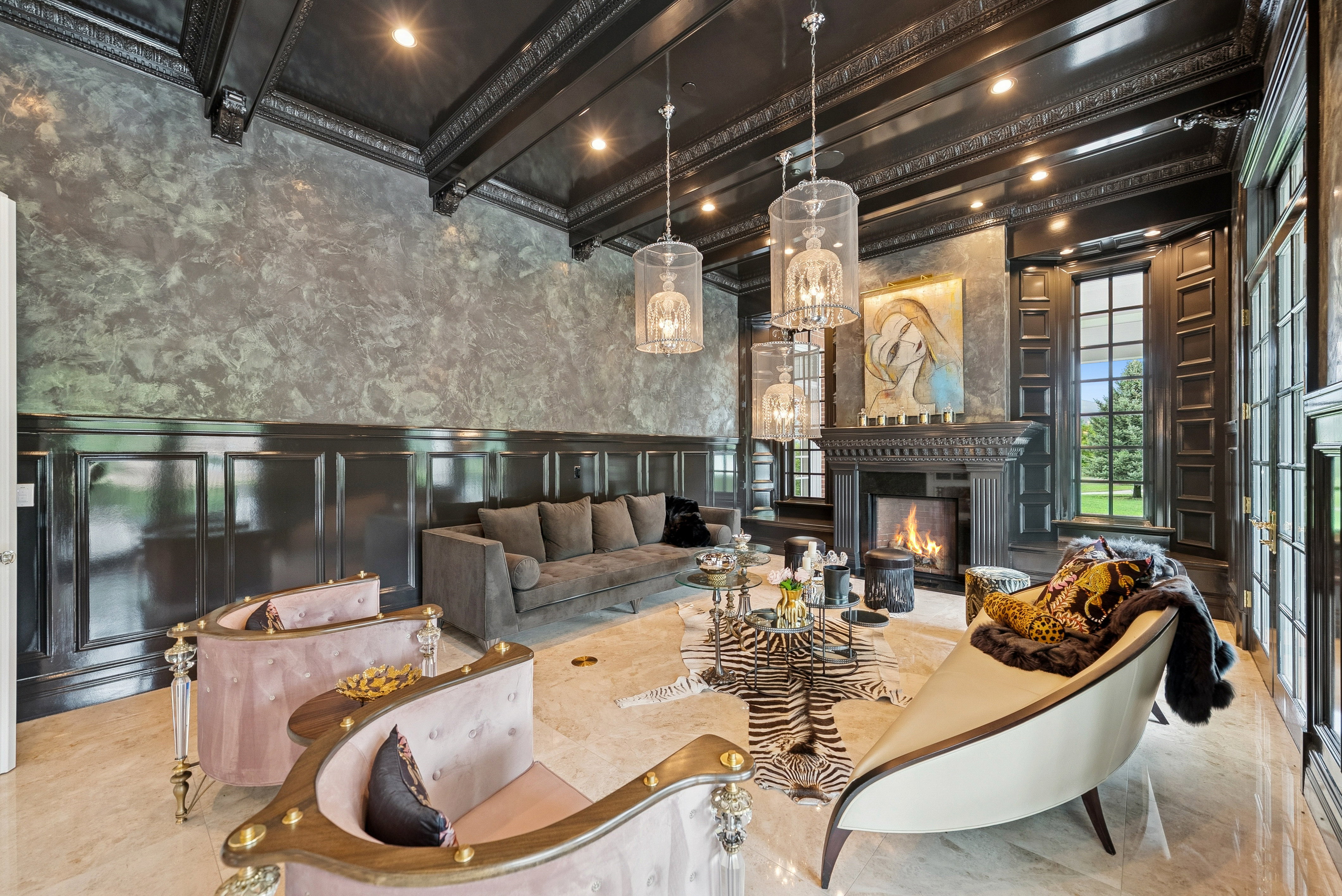 Grand living space featuring a dark wood coffered ceiling, wainscoting, and a detailed fireplace mantel