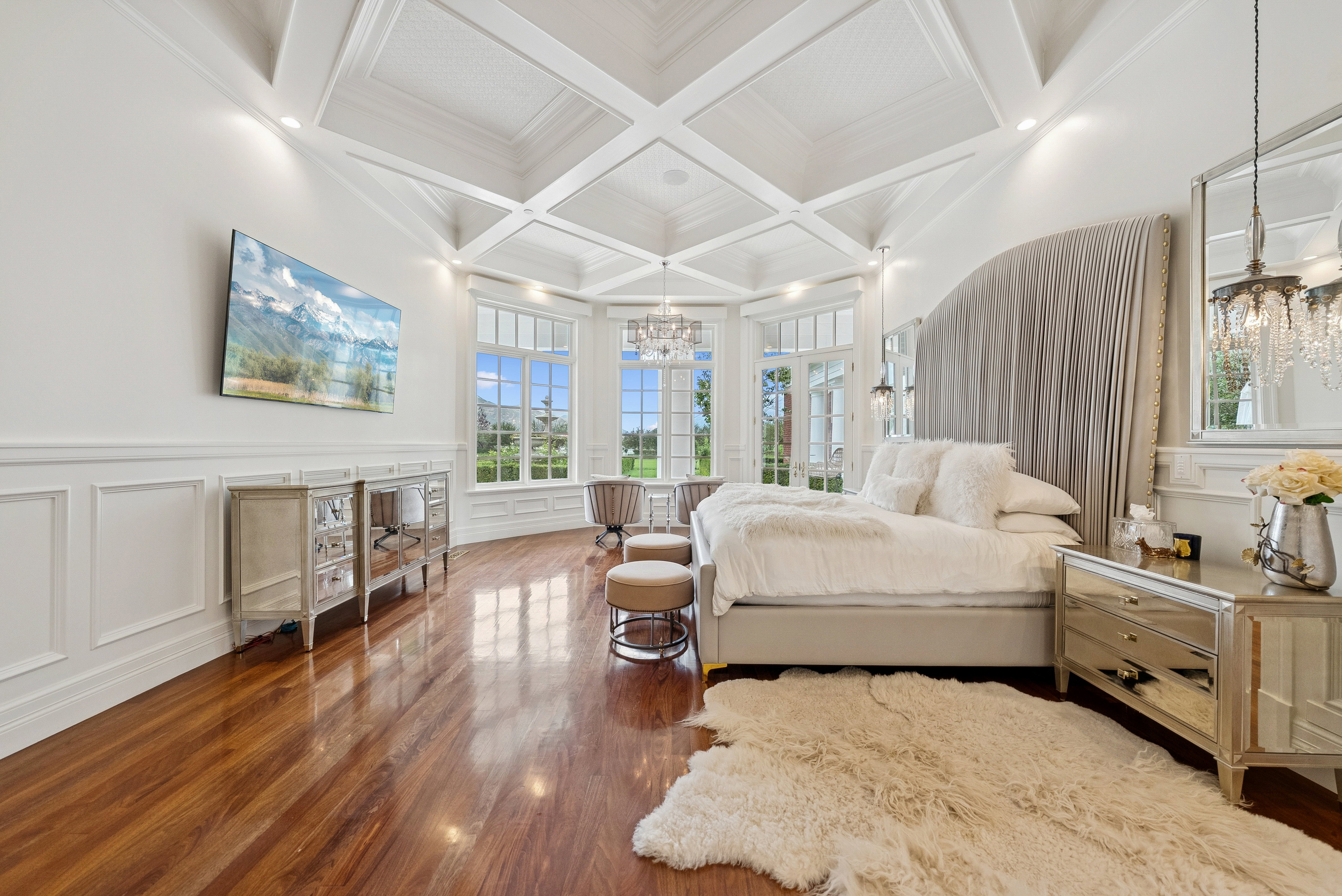 Vaulted coffered ceiling with recessed lighting, wood-finish flooring, and extensive wainscoting