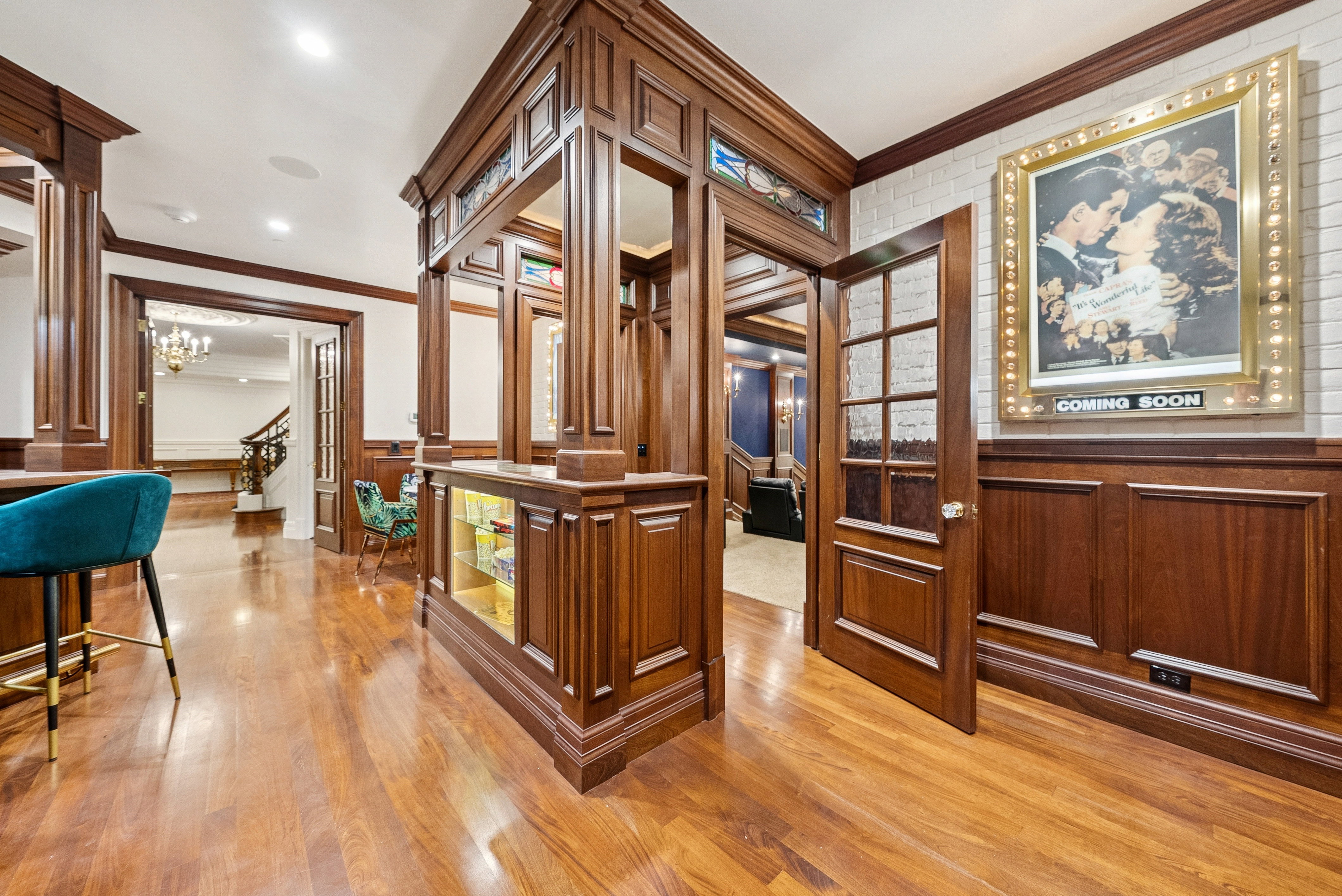 Rich wood-finish flooring complements intricate wood paneling and trim throughout this space