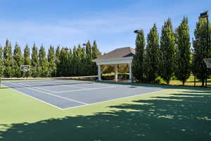View of tennis court featuring community basketball court