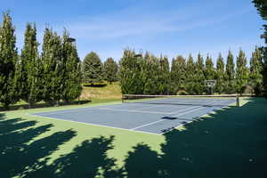 View of tennis court featuring community basketball court