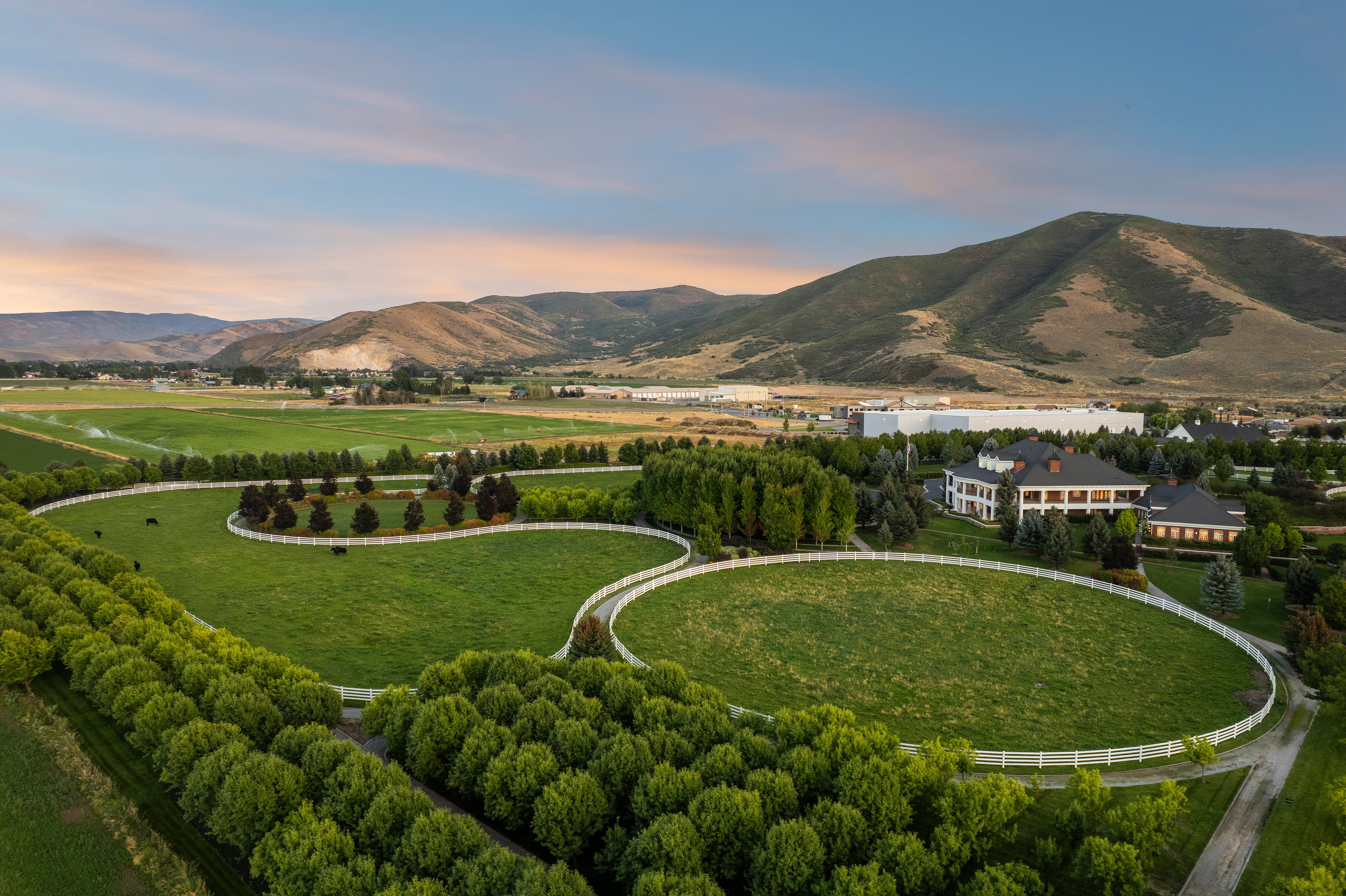 Expansive property featuring multiple fenced pastures and mature tree lines