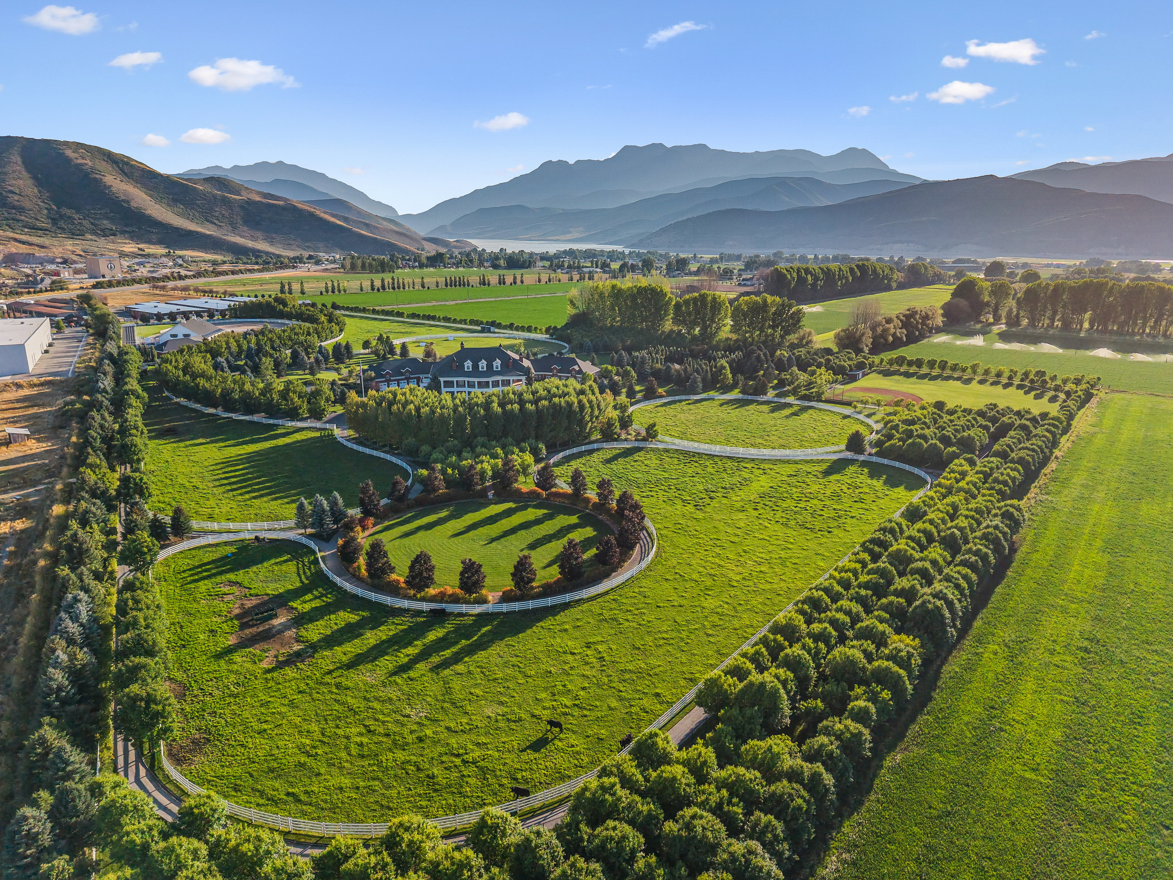 Expansive estate featuring a large main residence, multiple outbuildings, and extensive manicured grounds