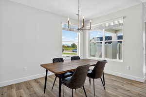 Dining room featuring a chandelier and light wood-type flooring