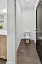 Bathroom featuring vanity and toilet