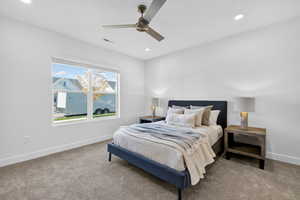 Carpeted bedroom with ceiling fan and recessed lighting