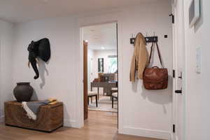 Hall featuring light wood-style floors and baseboards
