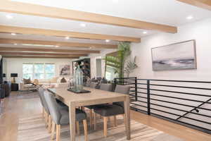 Dining room with beamed ceiling, light wood-type flooring, recessed lighting, and plenty of natural light