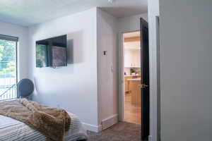Carpeted bedroom featuring access to exterior and baseboards