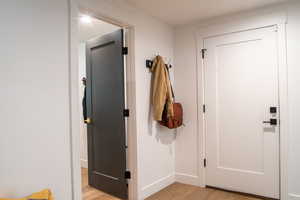 Doorway featuring wood finished floors