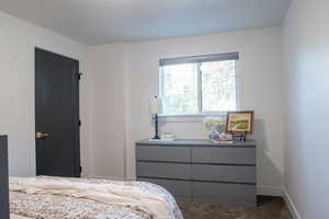 Bedroom with carpet flooring and baseboards