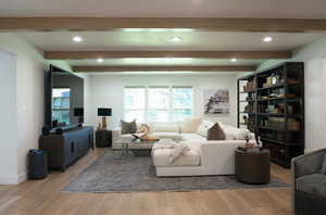 Living area with beam ceiling, recessed lighting, and wood finished floors