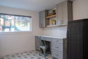 Office area with built in desk and washer / dryer