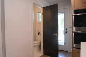 Bathroom with toilet and light wood finished floors