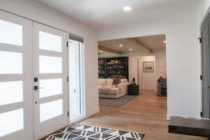 Entrance foyer with beam ceiling, light wood-type flooring, and recessed lighting