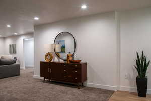 Living area featuring recessed lighting, a textured ceiling, and light carpet