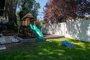 View of playground featuring a fenced backyard