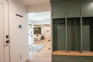 Mudroom with light wood-type flooring and recessed lighting