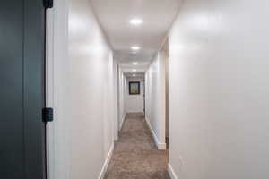 Hallway with carpet and recessed lighting